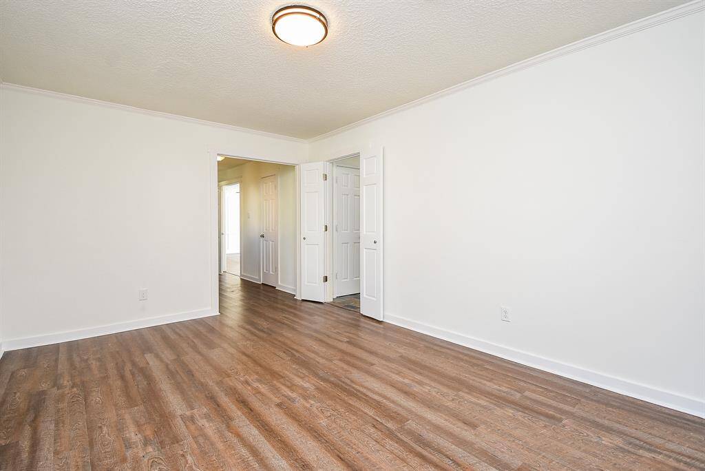 Bright and spacious formal Dining Room with neutral walls and wood-style vinyl luxury floor.