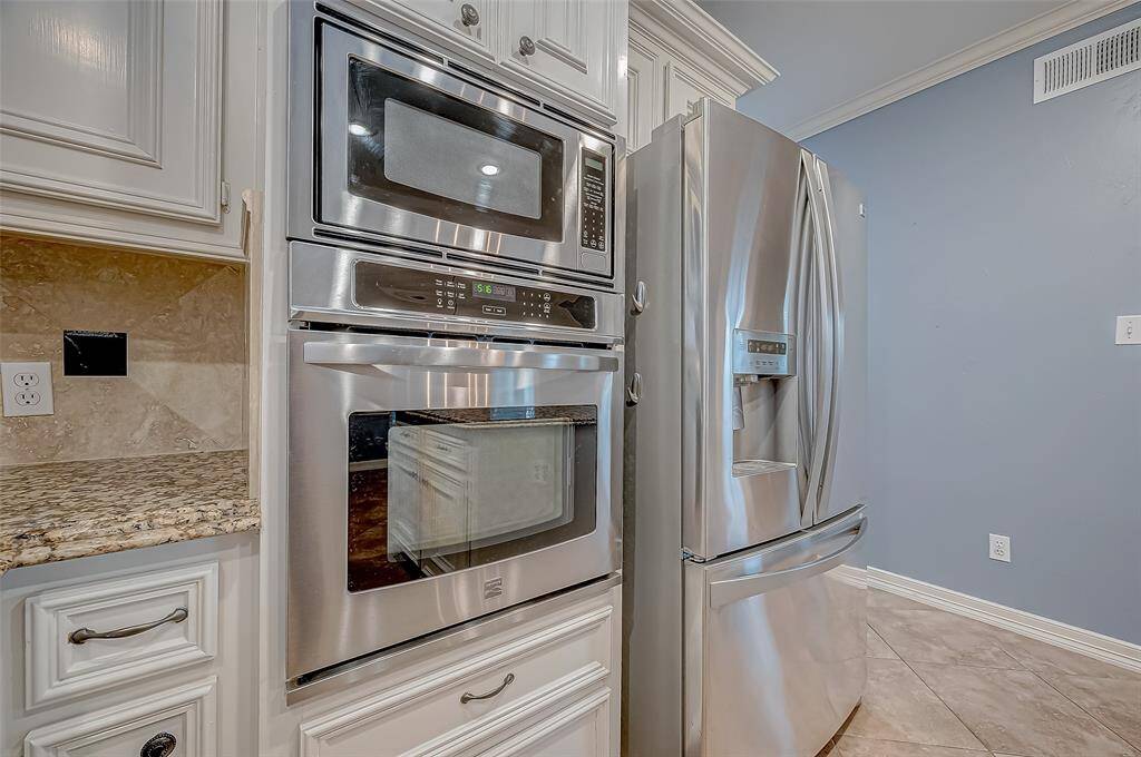 The kitchen offers stainless steel double ovens and a microwave.