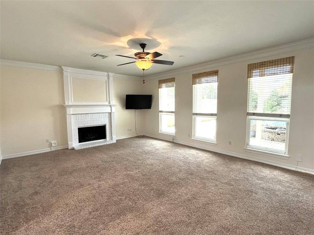 This vastly large Family room shows off the fireplace and the back yard.