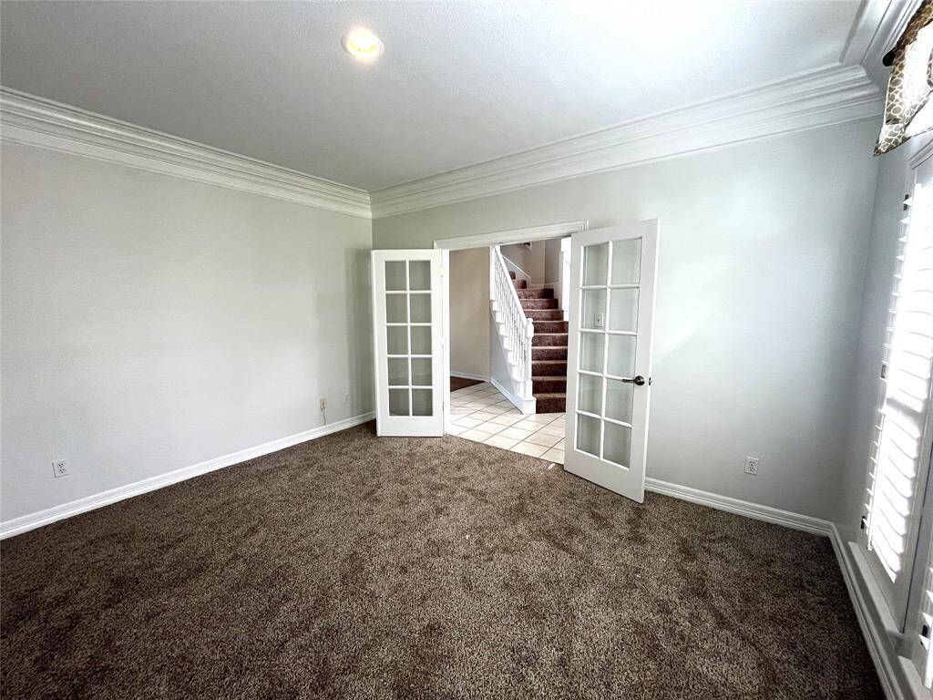 The study has double crown molding, plantation shutters as well as french doors for a quiet space.