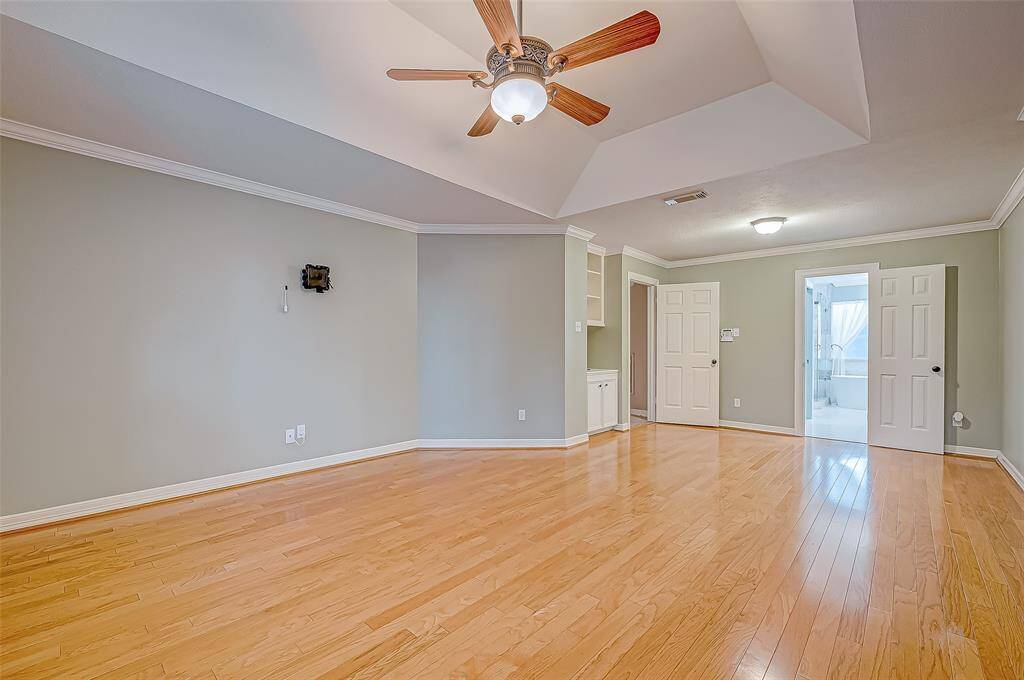 Another view of the primary showing off the beautiful real hard wood floors.