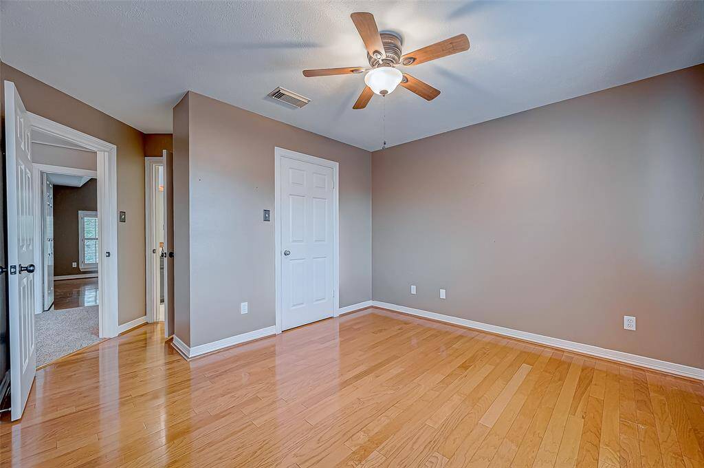 Fourth Bedroom with hardwood floors and a walk in closet.
