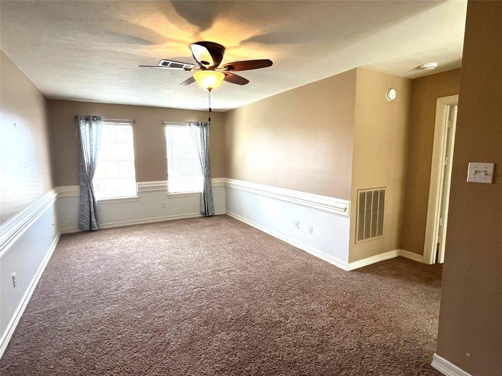 The Game room is centered around the upstairs bedrooms, plush carpet, chair railing and a ceiling fan.  There is also additional space where you can add a desk for study time.