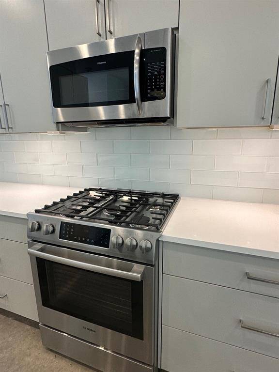 First floor living and dining. Island kitchen with stainless appliances and soft close hardware.