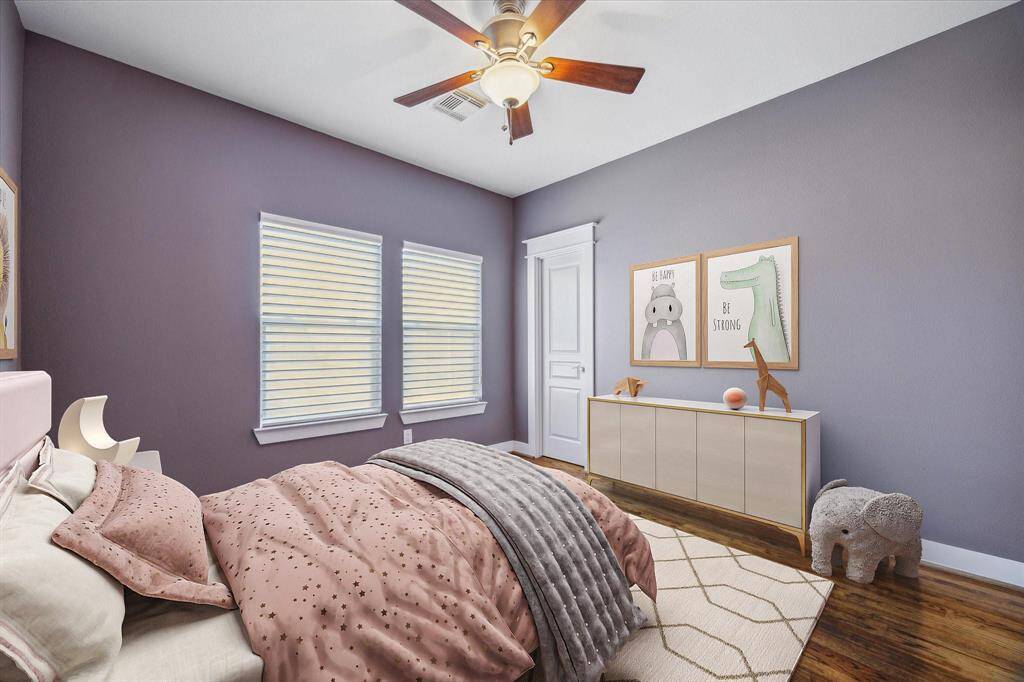 Spacious second bedroom with two large windows and walk-in closet.