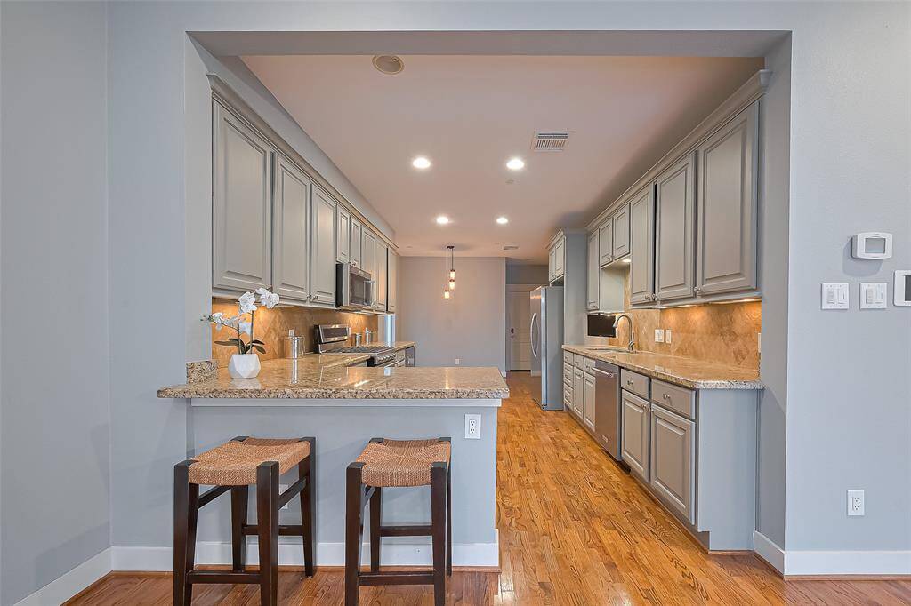 Easy access in and out the kitchen also has a walk-in pantry! Great cabinet space in this open kitchen with views of the backyard & pool!
