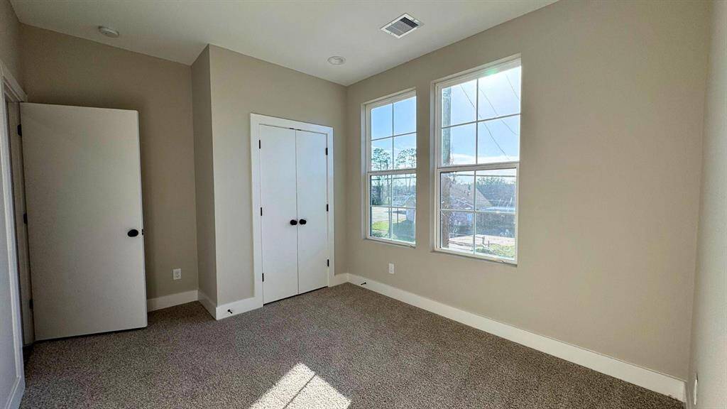 Second floor primary bedroom has large windows with lots of natural light for each room.