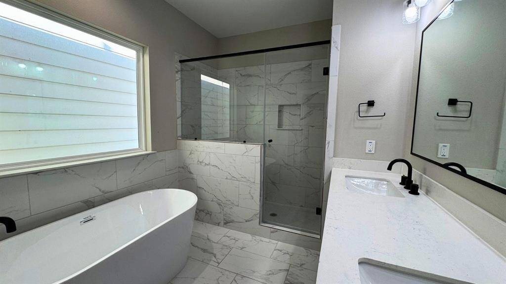 Primary bath retreat with separate shower and soaking tub.