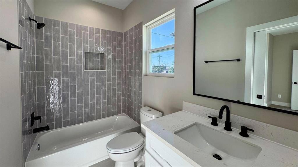 Secondary bathroom upstairs with combo tub and shower.