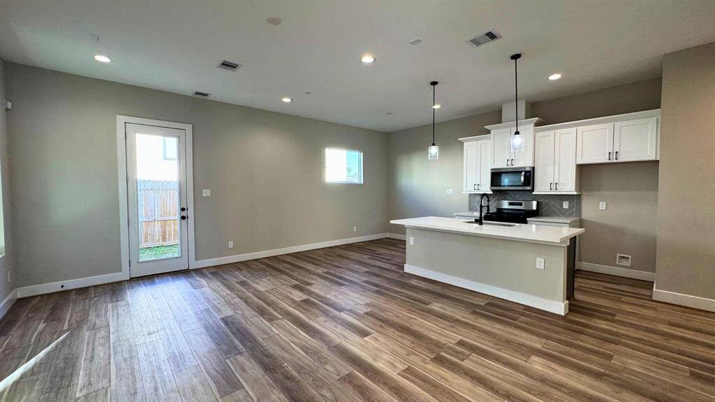 Open concept on the first floor opens the kitchen and living areas.