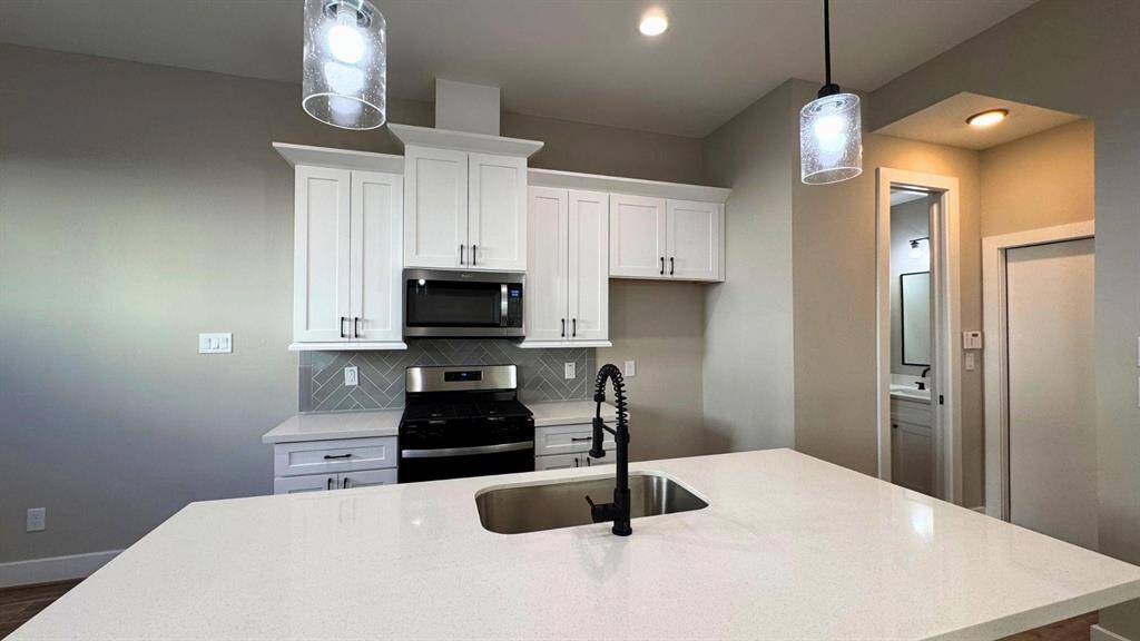 Pendumum lighting creates an intimate feel in the kitchen area.