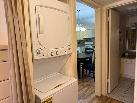 A compact laundry area with a New stacked washer and dryer set.