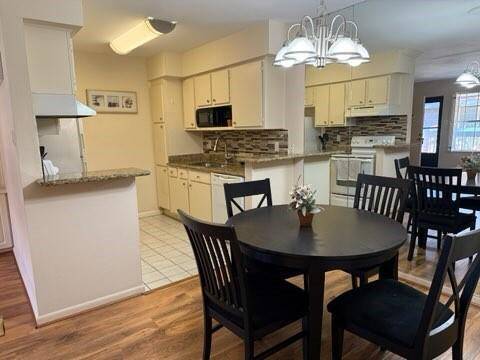 Cozy dining area connected to a bright kitchen.