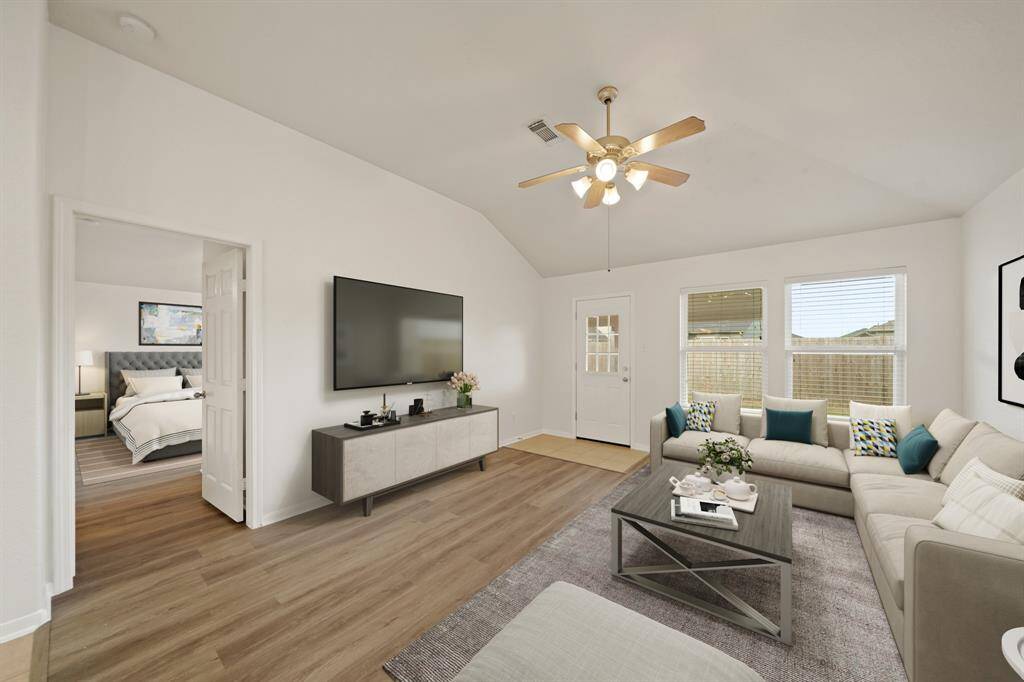 Virtually Staged: This stunning living area boasts high ceilings with a ceiling fan, beautiful wood floors, and easy access to your Master Suite.