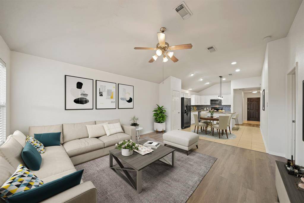 Virtually Staged: WOW! This living room is the perfect place to entertain family and friends as it offers a seamless, open floor plan. Easy access to your amazing kitchen and dining space!