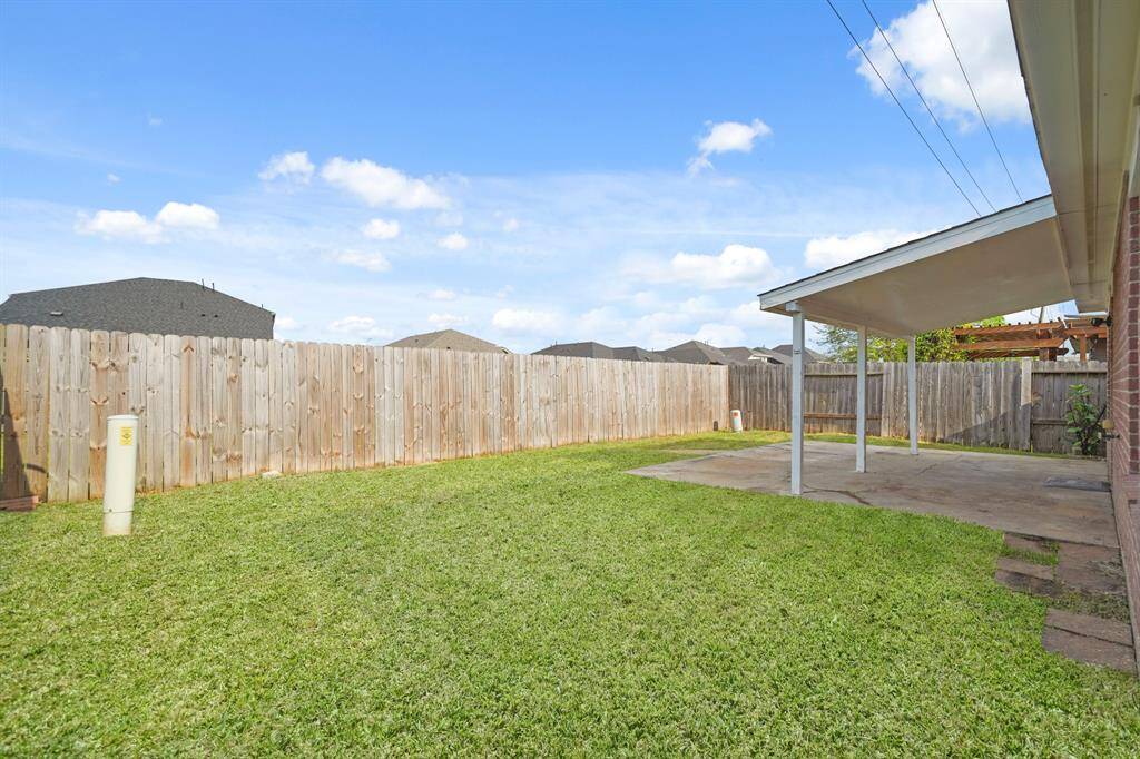 The backyard features a wooden fence for more privacy and security.
