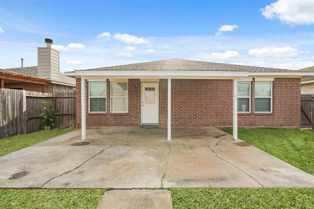 This large backyard features a great patio perfect for outdoor seating and dining.