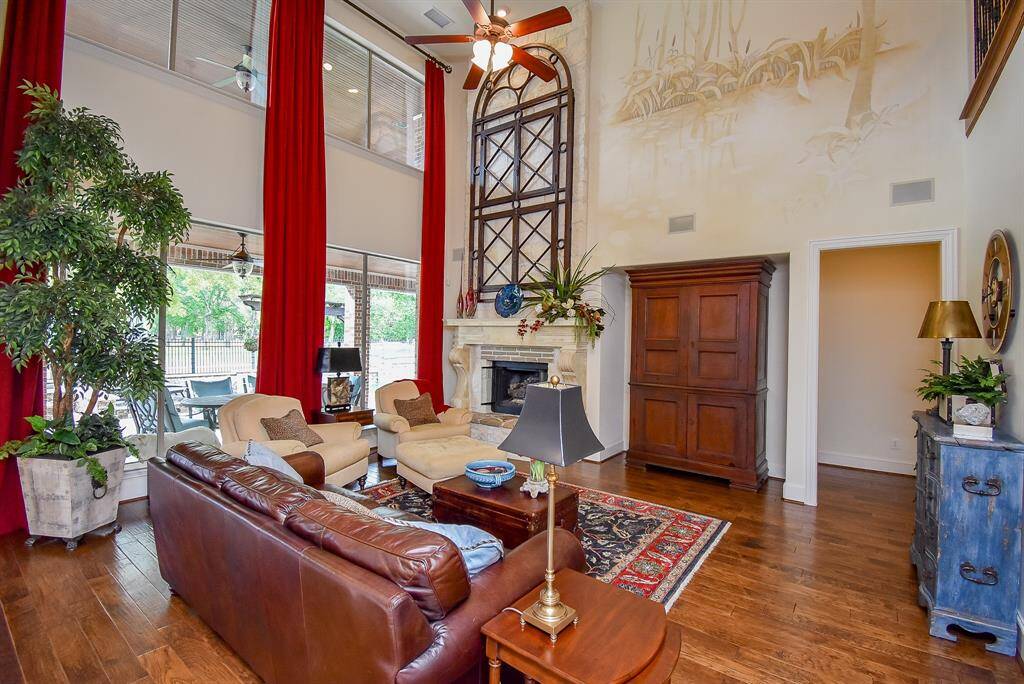 The two story family room boasts a gas log fireplace, fantastic views to the yard and golf course, a suttle artist mural and a niche for your furniture.