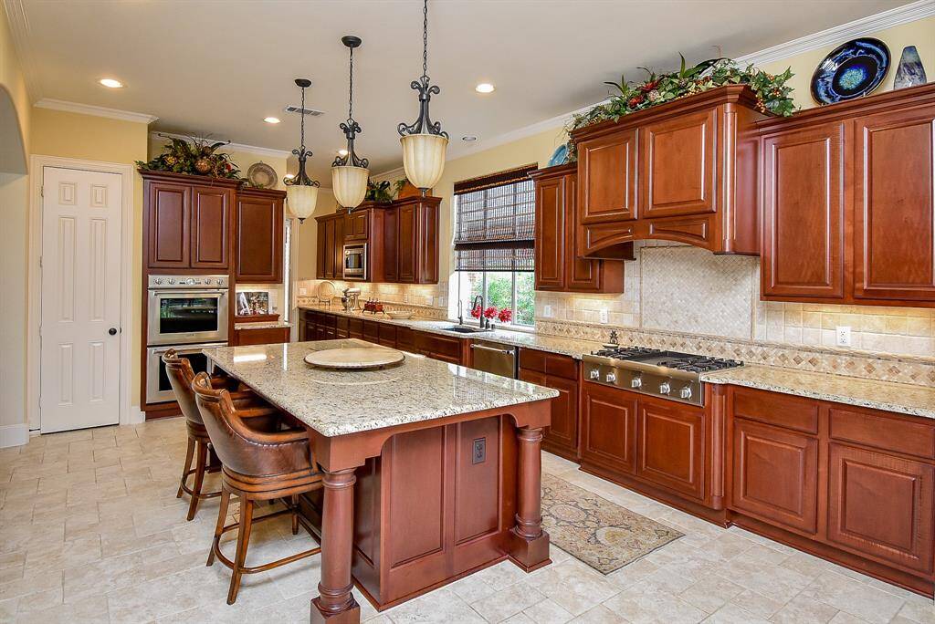 Gas cooktop, double oven and built in microwave bring joy to cooking Walk in pantry has good storage.