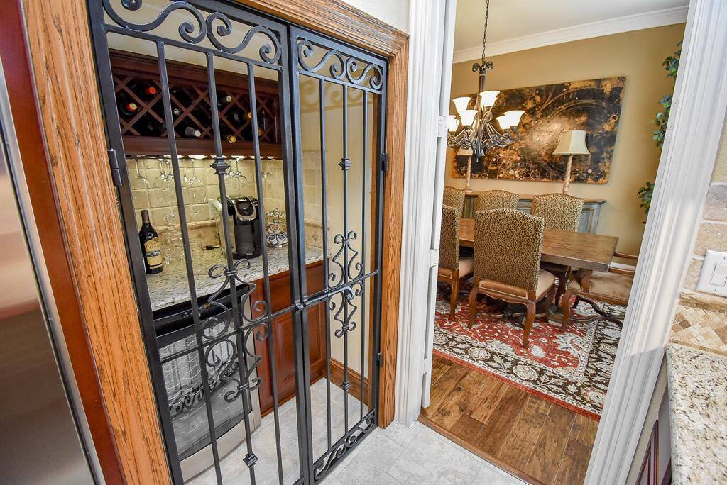 Wine grotto off the dining room is accented with iron gates.
