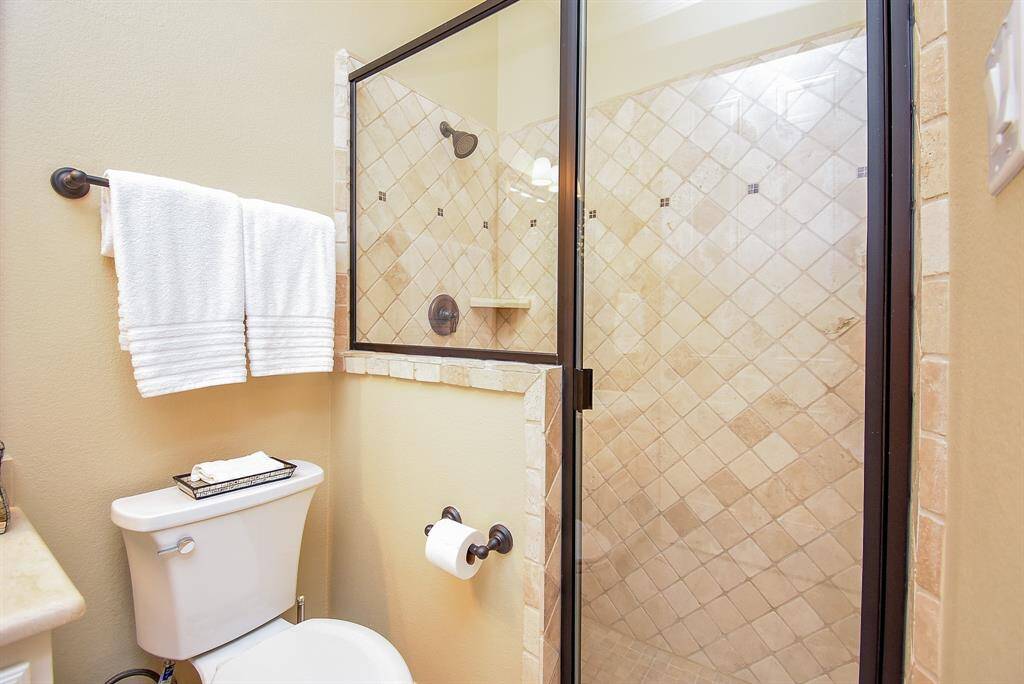 Ensuite bath for the second bedroom down. Nice walk in shower.