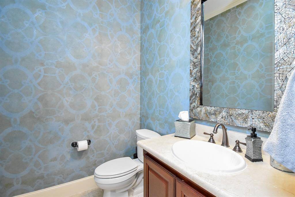 The half bath downstairs has custom painted walls.