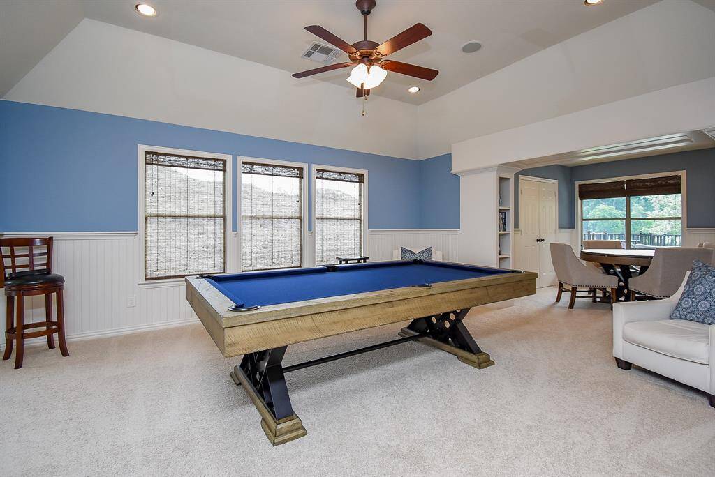 Spacious game room and card room with built in shelves.Wainscotting in the game room is  a nice accent.