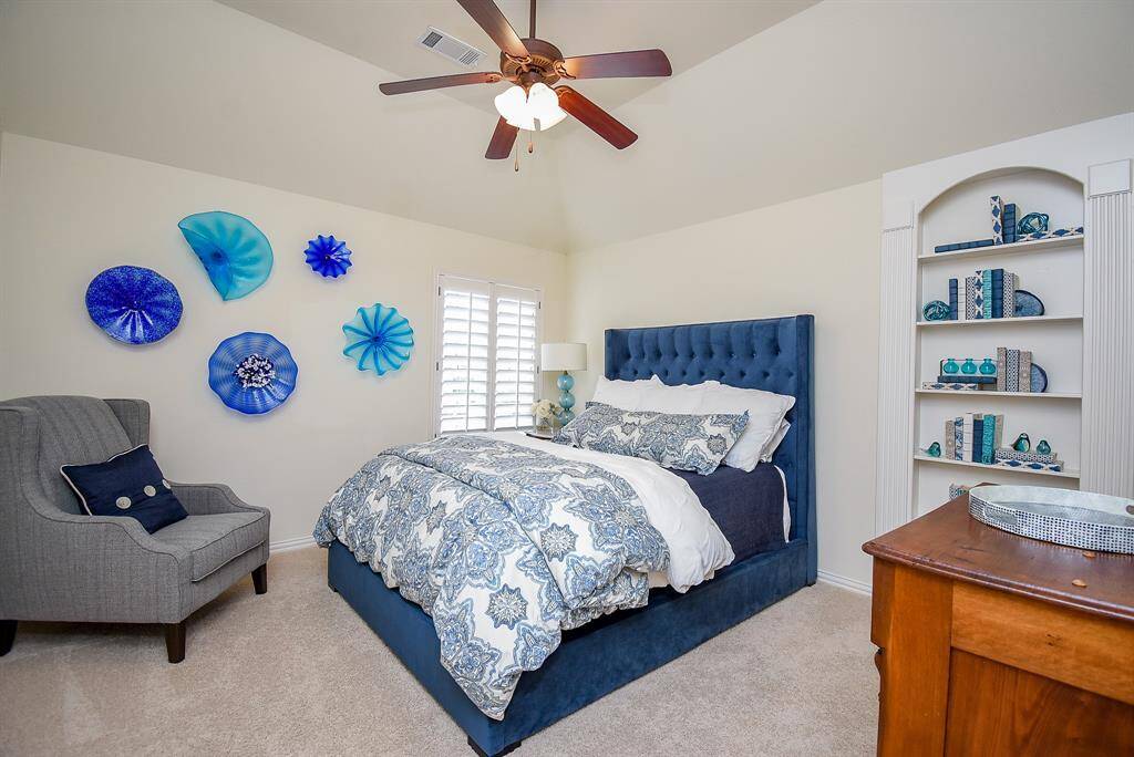 Secondary bedroom up has shelving which opens into the secret room Plantation shutters and raised ceiling.