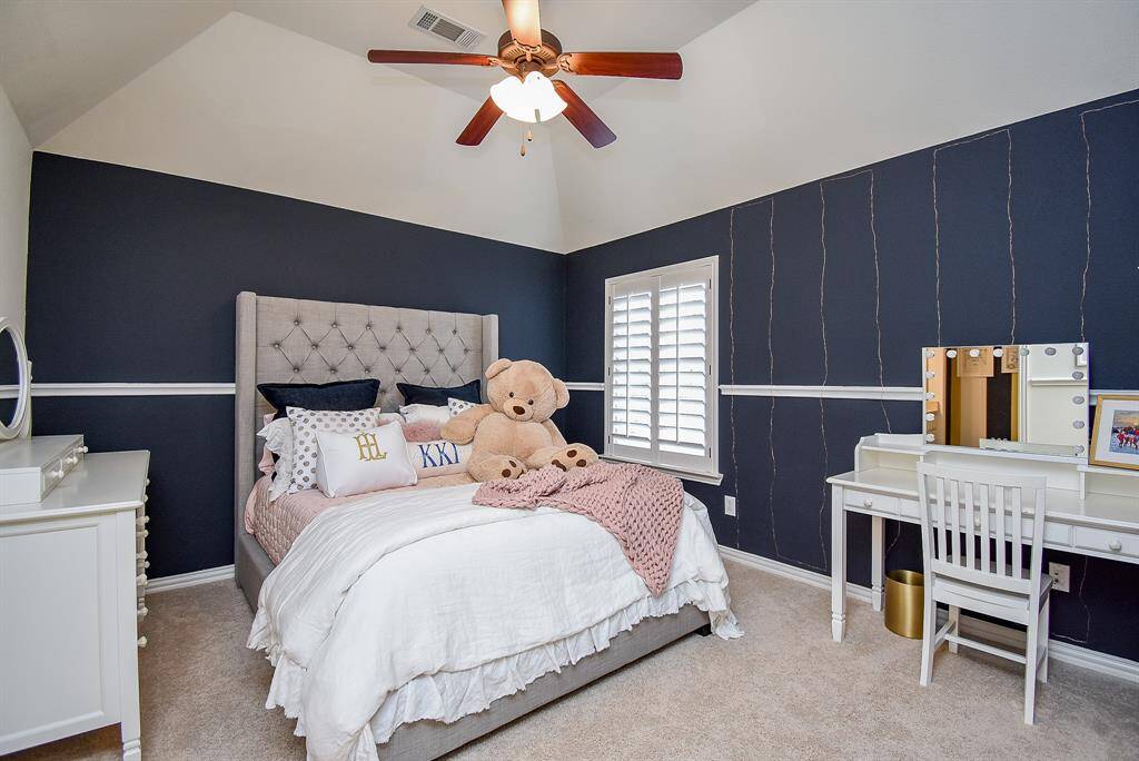 Secondary bedroom up has the raised ceiling, custom paint and plantation shutters.