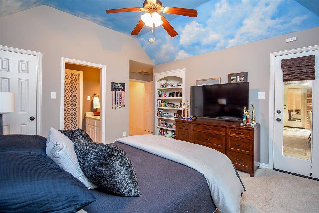 3rd bedroom up has custom painted clouds. What kid would not love this room. The built in bookcases are a nice touch. This room also has access to the balcony.