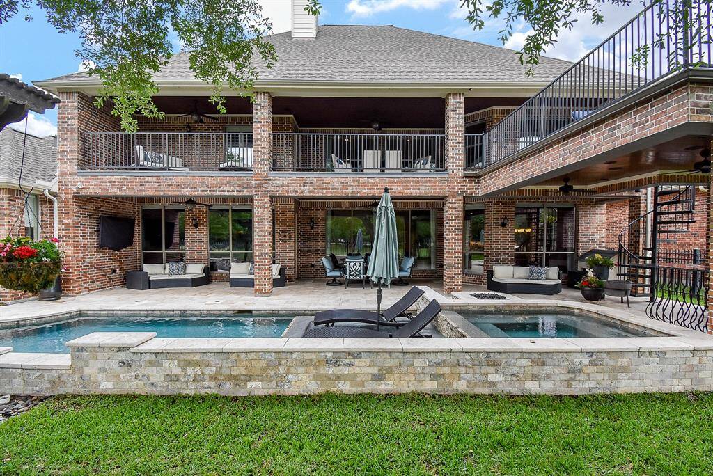 View of the rear elevation. All brick is low maintenance. Spiral staircase to the upstairs balcony makes it easy to enjoy activities upstairs and down.