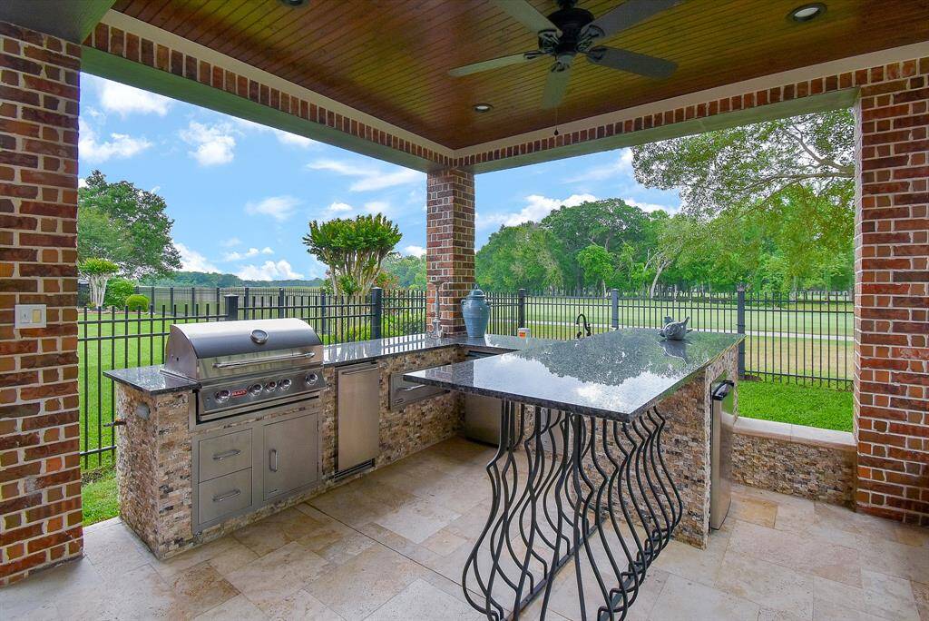 Grill, storage, beverage fridge and sink make it easy to cook outside. Nice bar area and lovely views of the course.