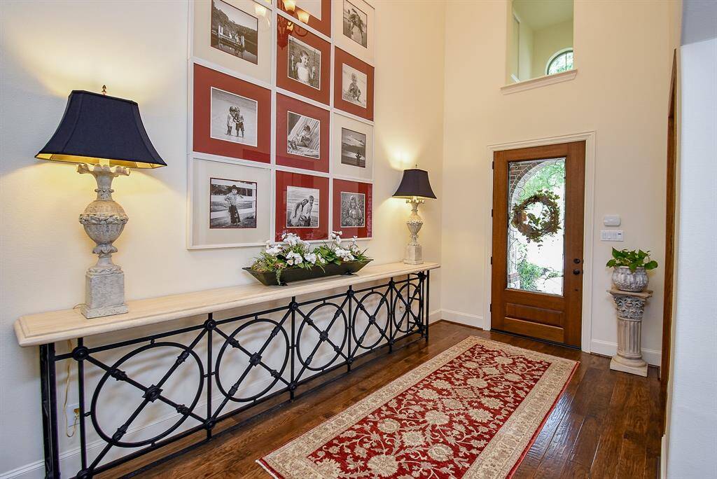Two story foyer allows natural light in and provides a nice wall to highlight photographs or art work. Hardwood flooring is warm and inviting.