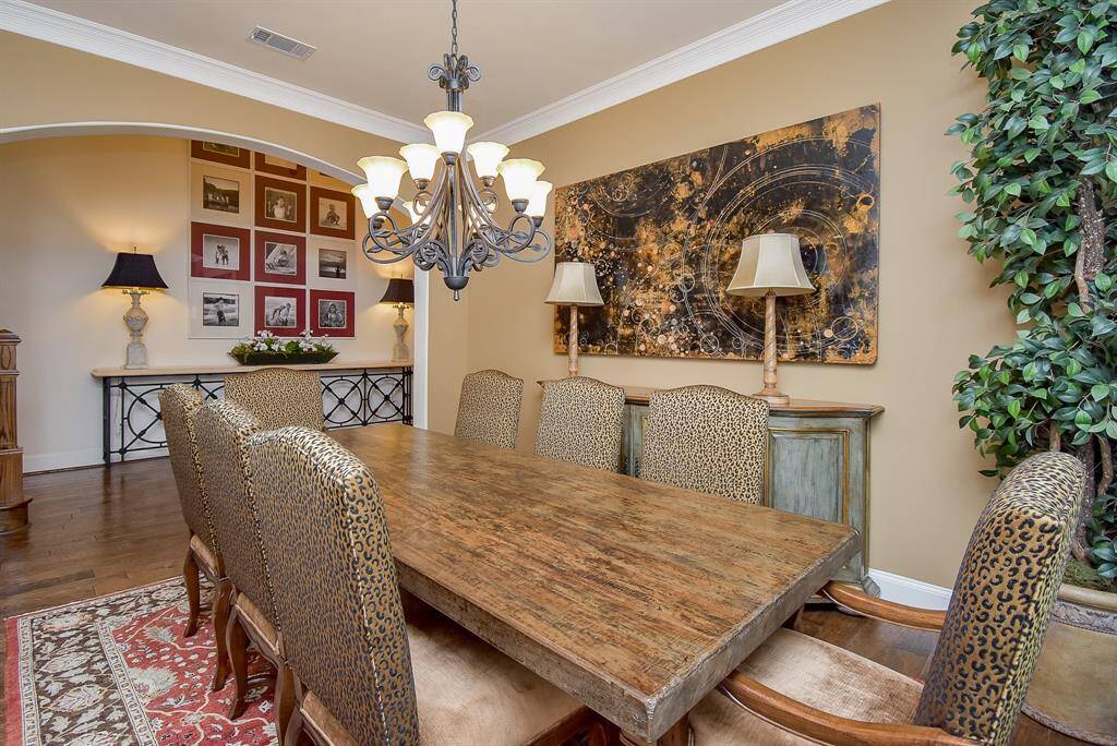 The formal dining room is spacious and has good wall space for your furnishings. The hardwoods continue from the entry throughout the living areas. Crown molding is a nice accent to the warm tones of the paint.