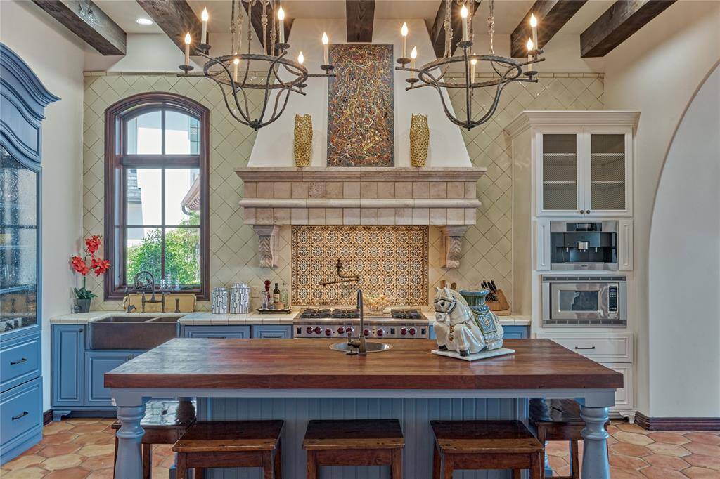 Classic tiles & rich butcher block island create a homey and inviting space to cook and converse with friends and family.