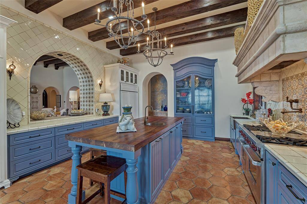 The kitchen is open to the breakfast room and living room with a custom tiled buffet niche and ceiling.