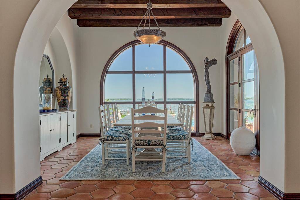 Tranquil breakfast room framed by impressive windows and amazing views of the lake.