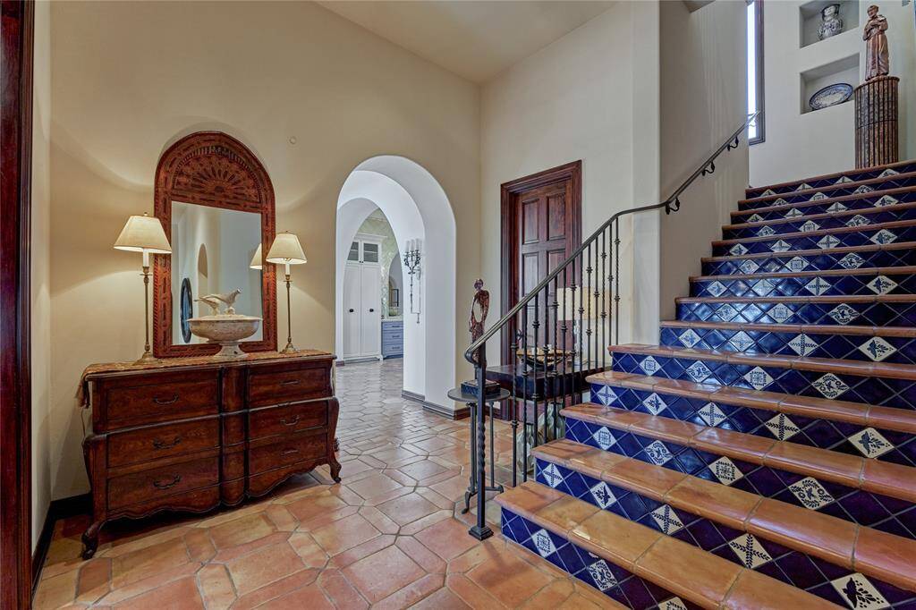 Walk ways are spacious and open. The staircase boasts incredible architectural detailing and is tucked off the garage and MUD area yet central to the home's living spaces.