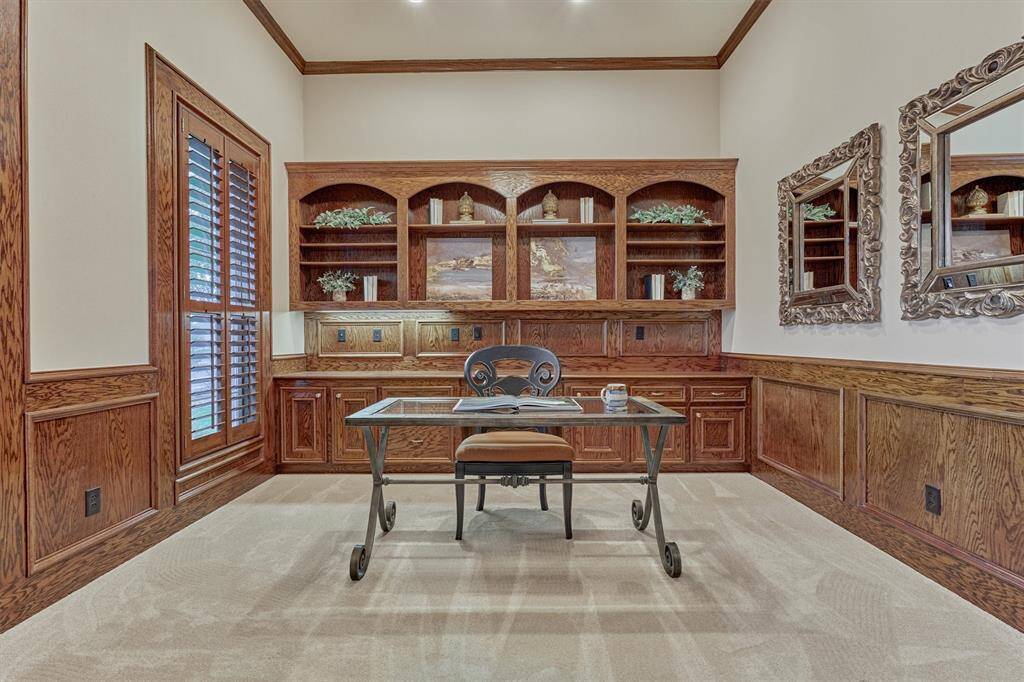 The home office boasts of rich wood cabinetry and provides a comfortable space for work or study. Open shelving for all of your book collections and ample storage beneath for supplies.