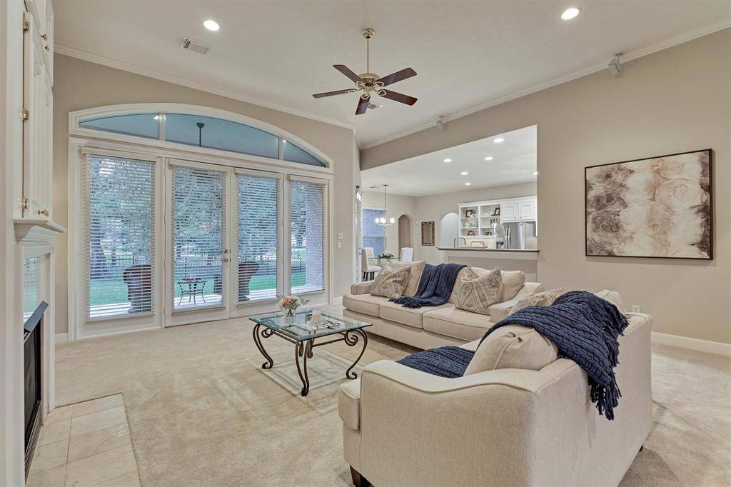 The living room is open to the kitchen and has beautiful views of the back yard.