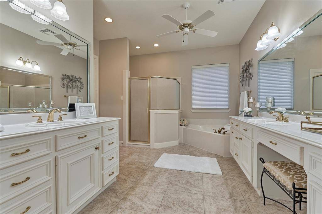 The primary ensuite features his and hers vanities, a relaxing soaker tub and a separate shower.