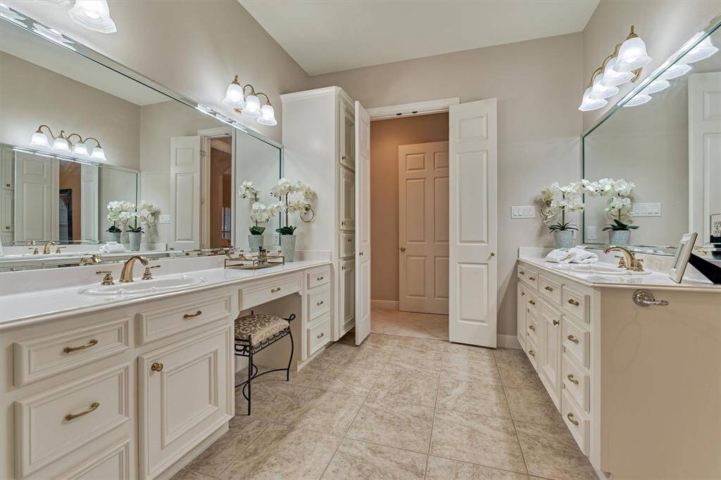 The primary ensuite has more than enough storage to house all of your powder room toiletries.