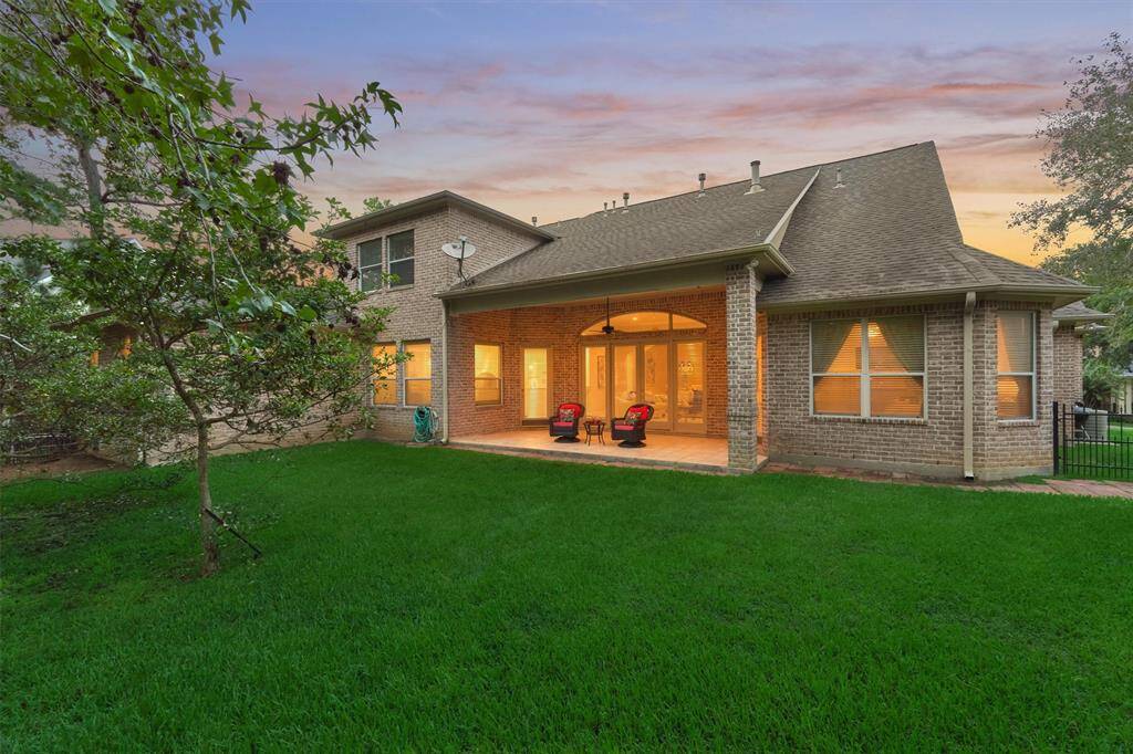 This is the back elevation of the home showing the covered outdoor patio. The exterior is 100% covered with a brick surround.