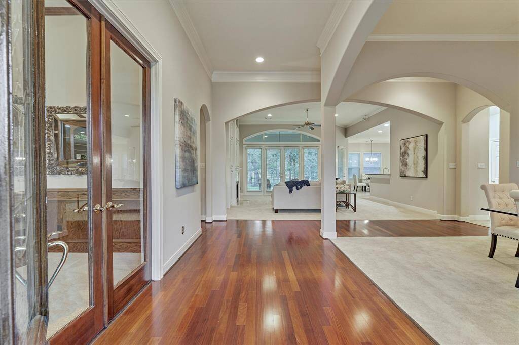 As we step into the foyer, the open and airy dining room is to your right and the home office is to your left.