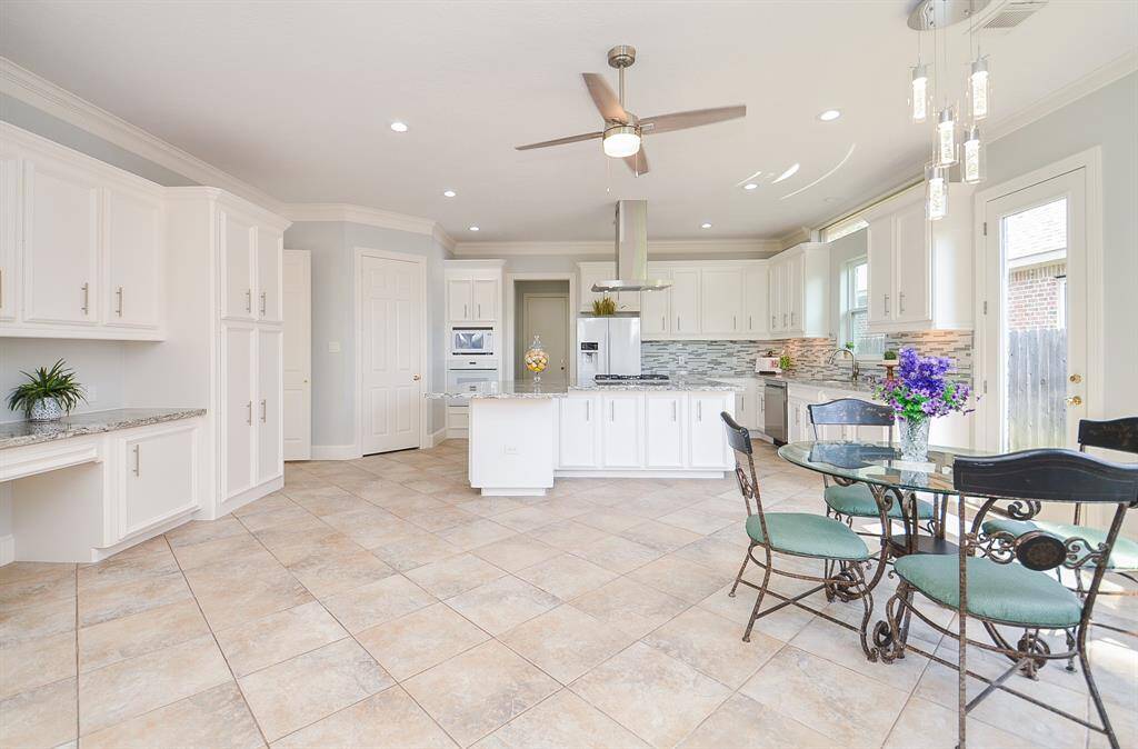 The Breakfast Area is Surrounded by Large Windows and is Conveniently Located Next to the Kitchen.