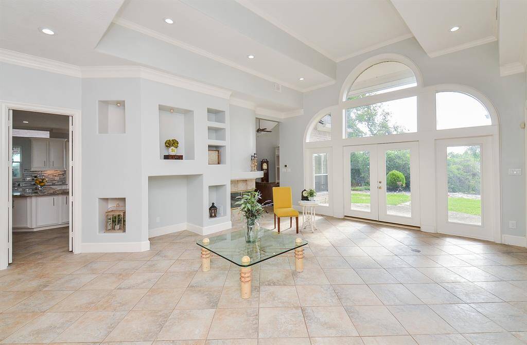 Great Room Features Raised Coffered Ceilings and Built-in Niches.