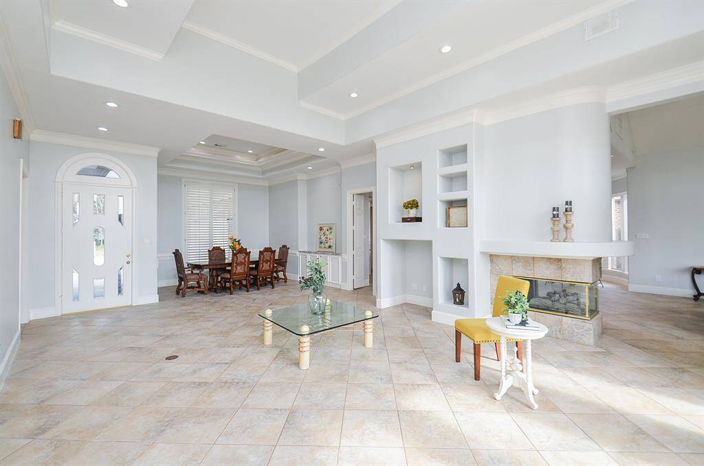 This Grand Room is the Heart of the Home, where a Double-Sided Fireplace Creates the Ultimate Focal Point and Conversation Piece.