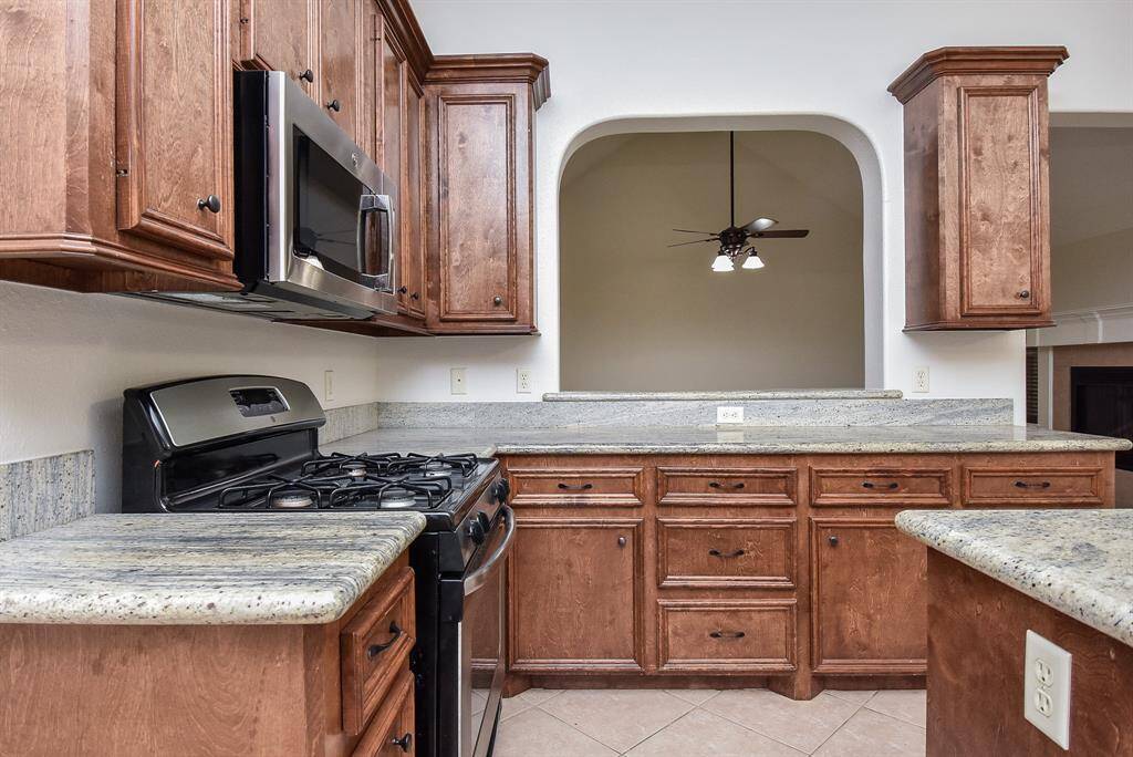 Everything is within fingertip reach, with creamy granite counters providing great work surfaces for everyday and special day occasions. The wall cut outs add interest and intimacy, too.