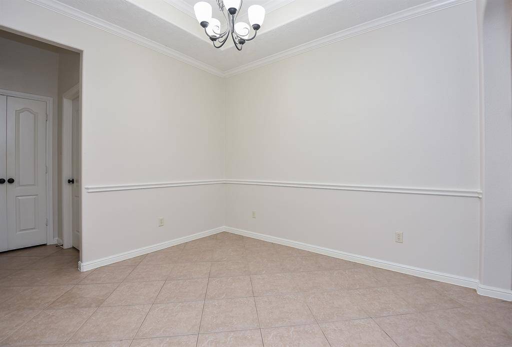 It's the little things in home detail that make for big enjoyment. Here, the formal dining area is embraced from above by a cozy tray ceiling and classic crown molding, which instantly personalizes a room; and sophisticated chair railing detail.