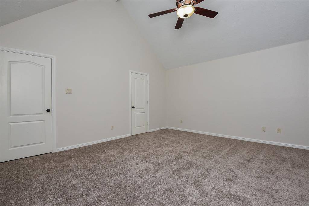 The high ceiling sits above earth toned carpeting and cool walls --- and space galore!